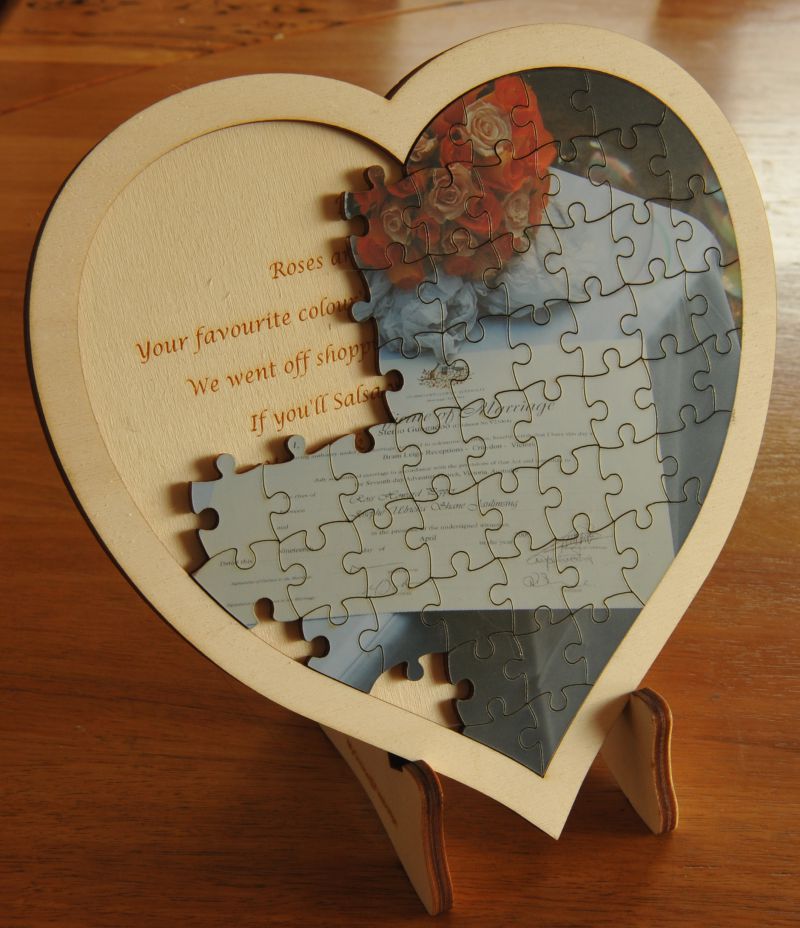 Heart jigsaw on timber frame and stand ( pieces removed to show text on stand )