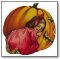 Halloween girl with red bow kneeling next to punmkin 187